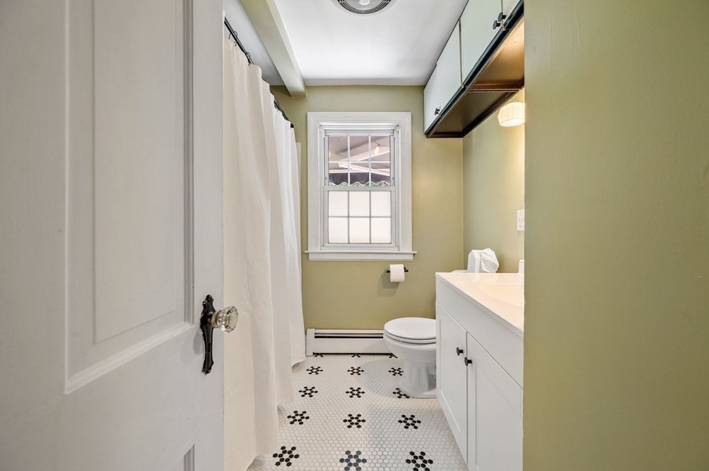 100 Winifred Avenue Worcester, MA 01602 - Photo 11 of 34 a bathroom with a granite countertop toilet and a shower curtain