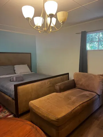 a bedroom with bed and window