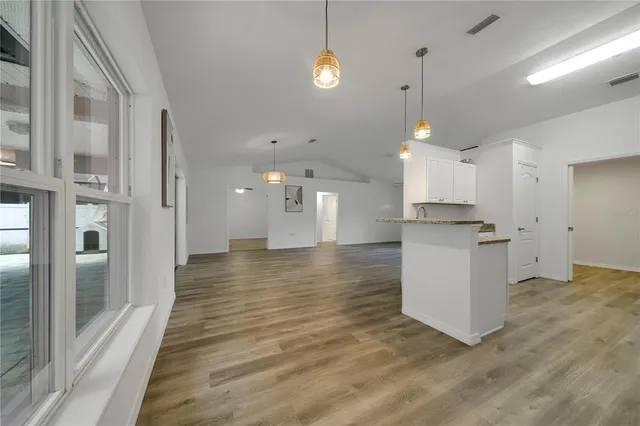 a view of a kitchen with an empty space and a window