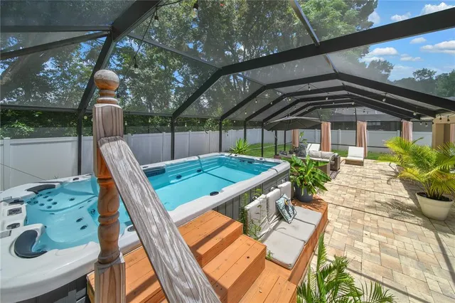 a backyard of a house with table and chairs