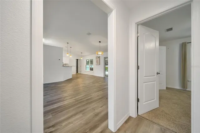 a view of a hallway with wooden floor