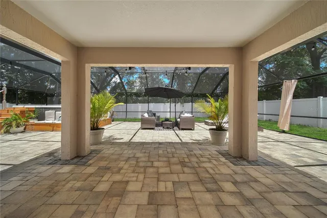 a view of a porch with dining table and chairs