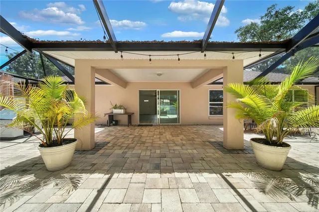 a view of a patio with table and chairs