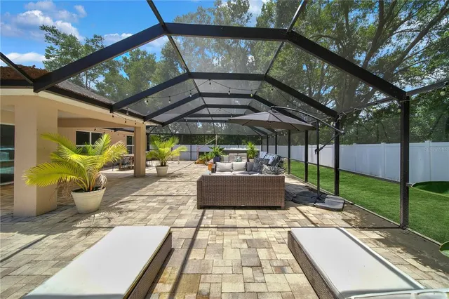 a view of a patio with table and chairs potted plants with wooden floor and fence