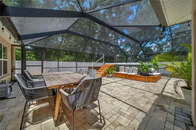 a patio with a patio table and chairs