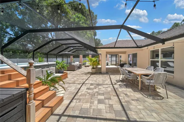 a view of a patio with a table and chairs under an umbrella