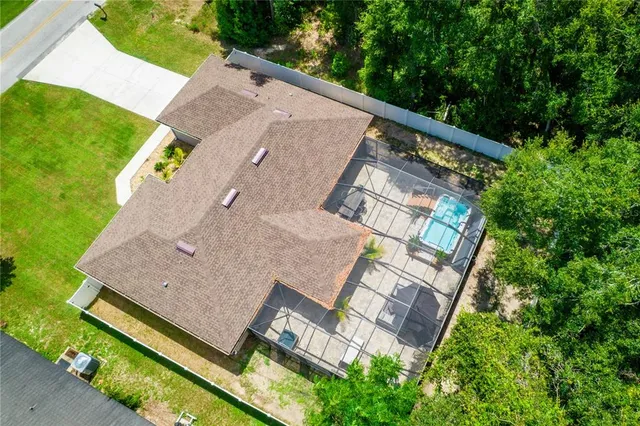 an aerial view of a house with a yard