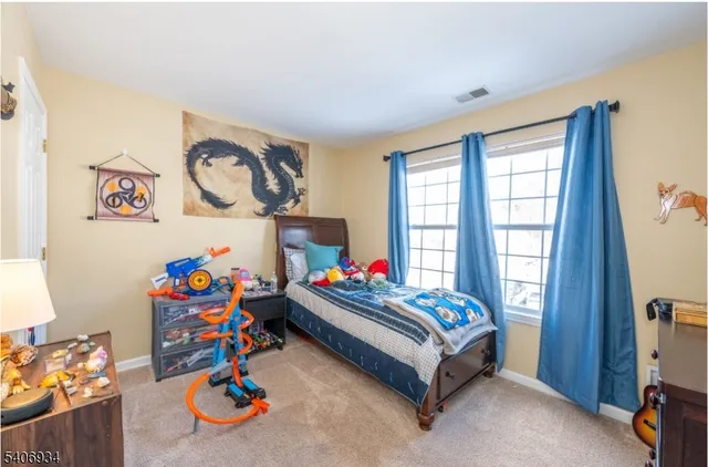 a bed sitting in a bedroom next to a window