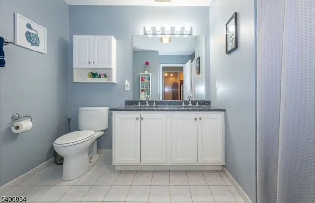 a bathroom with a sink toilet and mirror