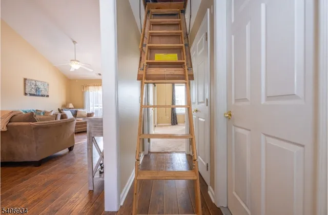 a view of a hallway with wooden floor and windows