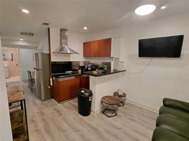 a kitchen with a sink appliances and cabinets