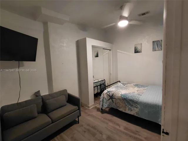 a bedroom with bed and a flat screen tv