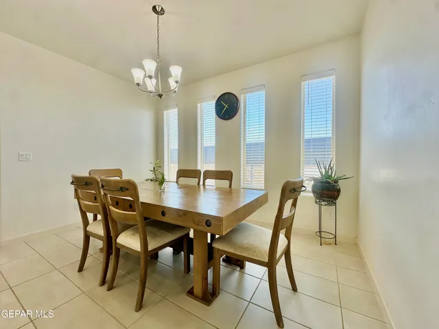 a view of a dining room with furniture and chandelier