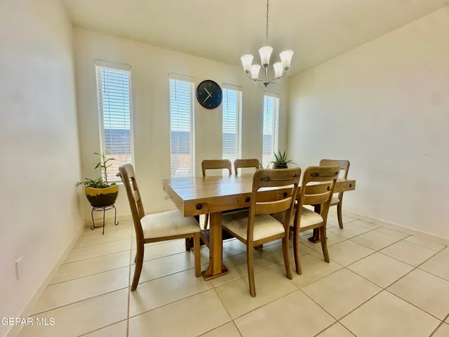 a view of a dining room with furniture and a chandelier