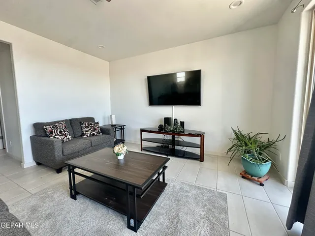 a living room with furniture and a mirror
