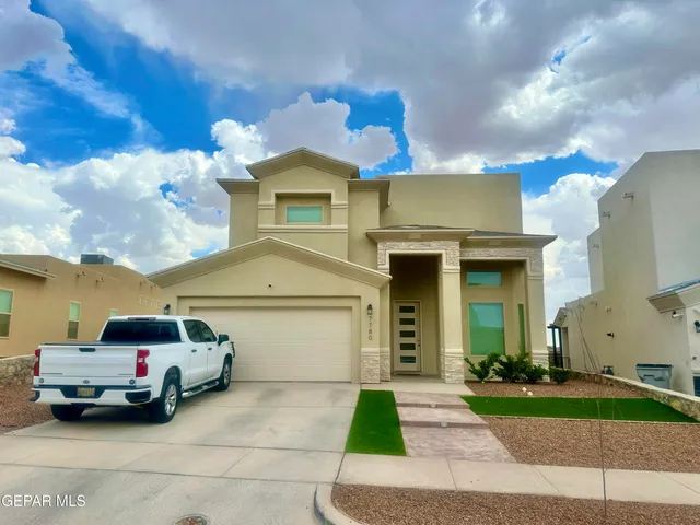 a front view of a house with a yard and garage