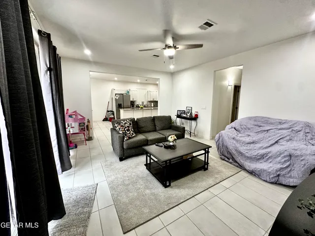a view of a hallway with furniture and wooden floor