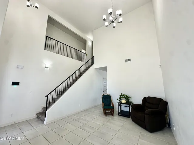 a living room with furniture and a chandelier
