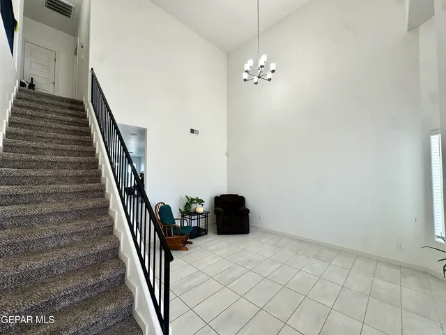 a view of a livingroom with furniture and chandelier fan