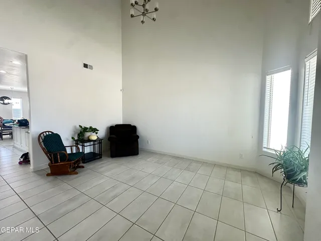 a large white kitchen with lots of counter top space and stainless steel appliances