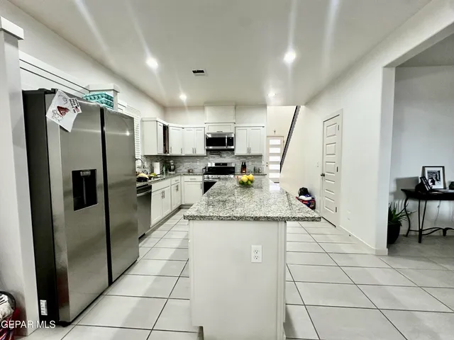 a kitchen with counter top space and refrigerator