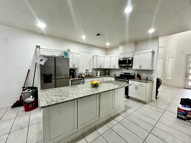 a kitchen with refrigerator and microwave