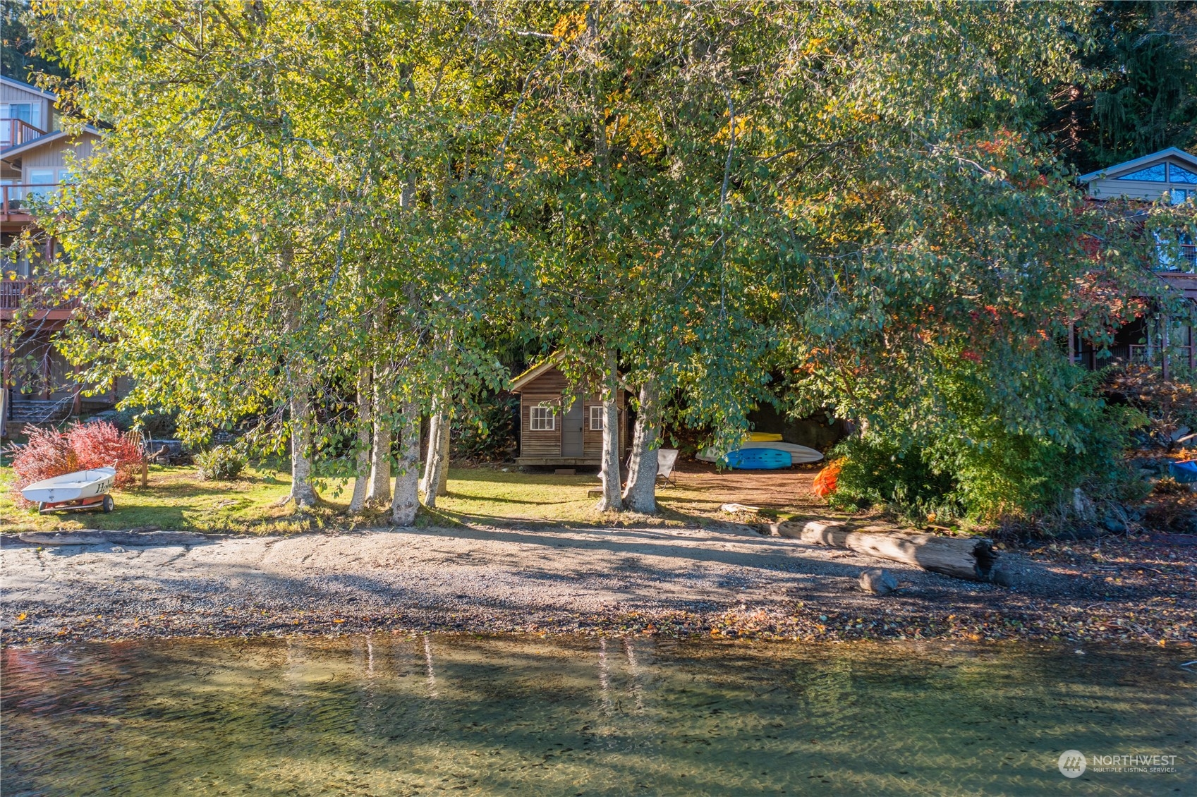 a view of swimming pool with lawn chairs and plants