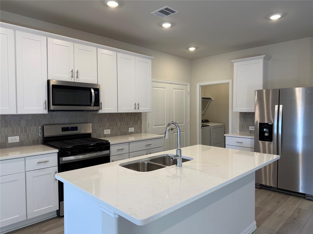 1736 Arches Road Anna, TX 75409 - Photo 3 of 18 Kitchen featuring stainless steel appliances, light stone countertops, backsplash, and recessed lighting