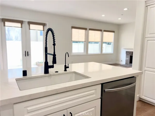 a view with granite countertop sink and natural light