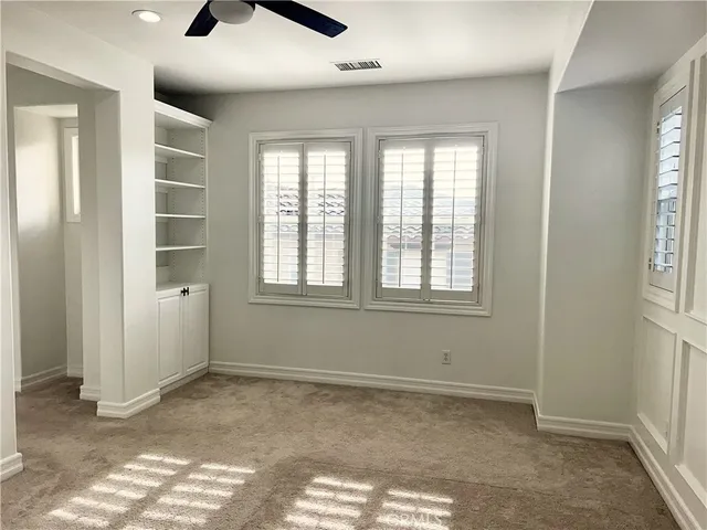an empty room with windows and closet