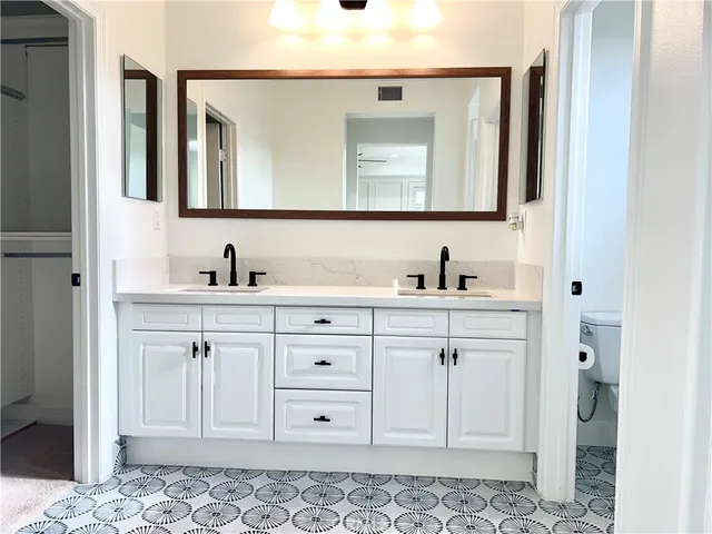 a bathroom with a sink vanity and mirror