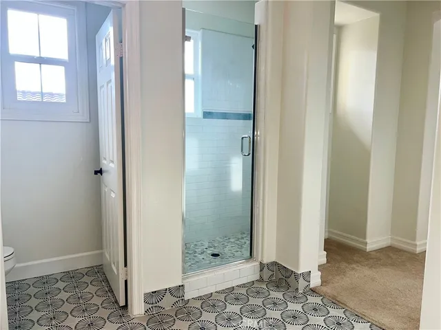 a bathroom with a glass shower door