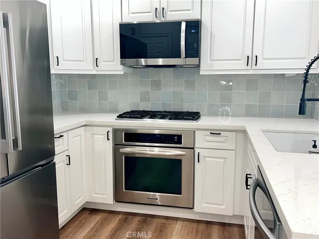 a kitchen with a stove and a microwave