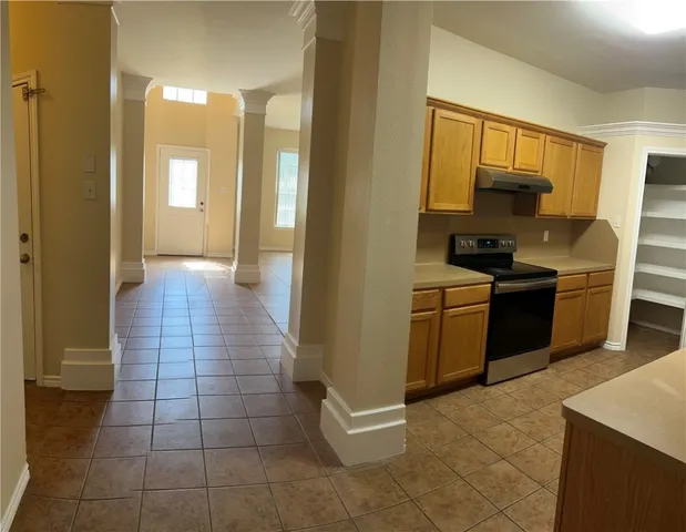a kitchen with a sink a stove and cabinets