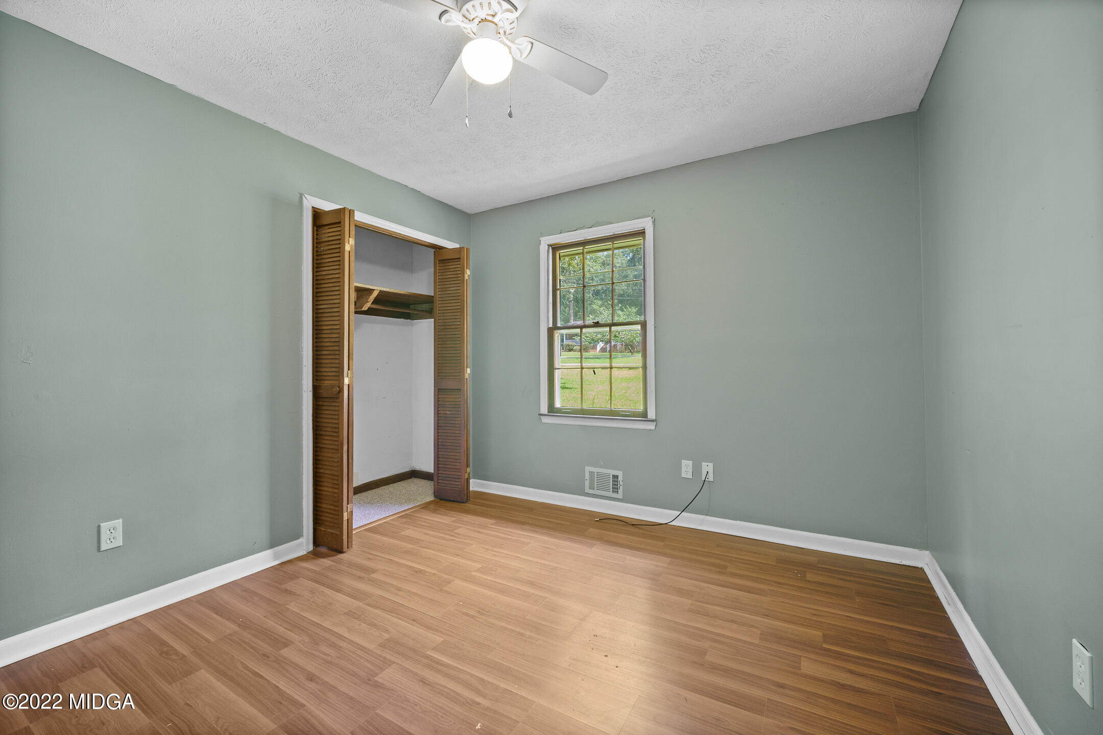 194 Short Street Jackson, GA 30233 - Photo 14 of 31 a view of an empty room with wooden floor and a window
