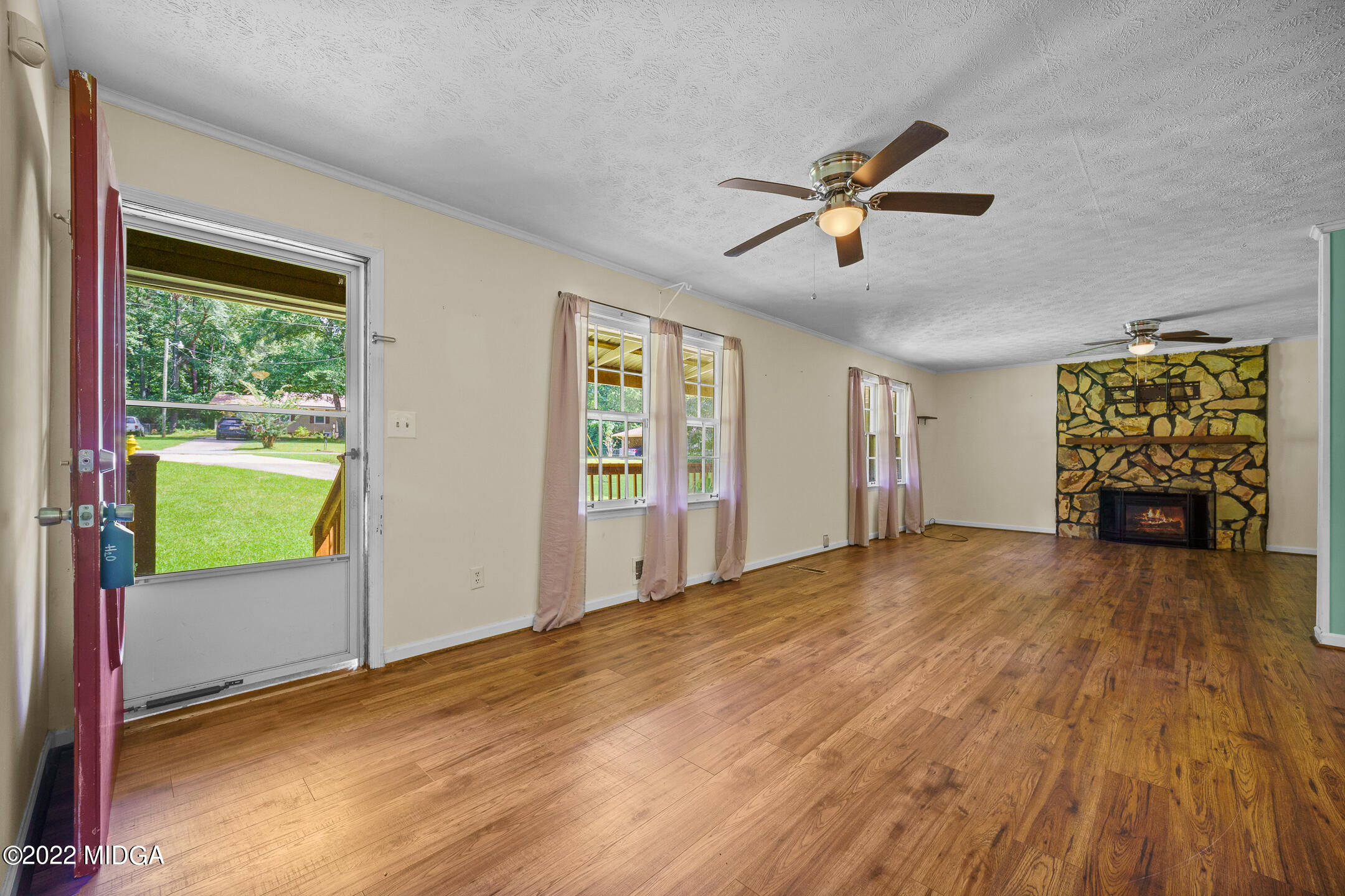 194 Short Street Jackson, GA 30233 - Photo 3 of 31 a view of an empty room with window and wooden floor
