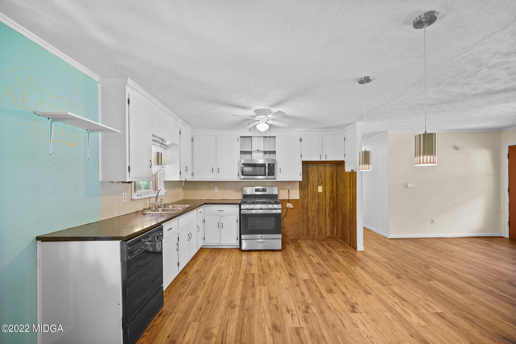 194 Short Street Jackson, GA 30233 - Photo 10 of 31 a large kitchen with a wooden floor and stainless steel appliances