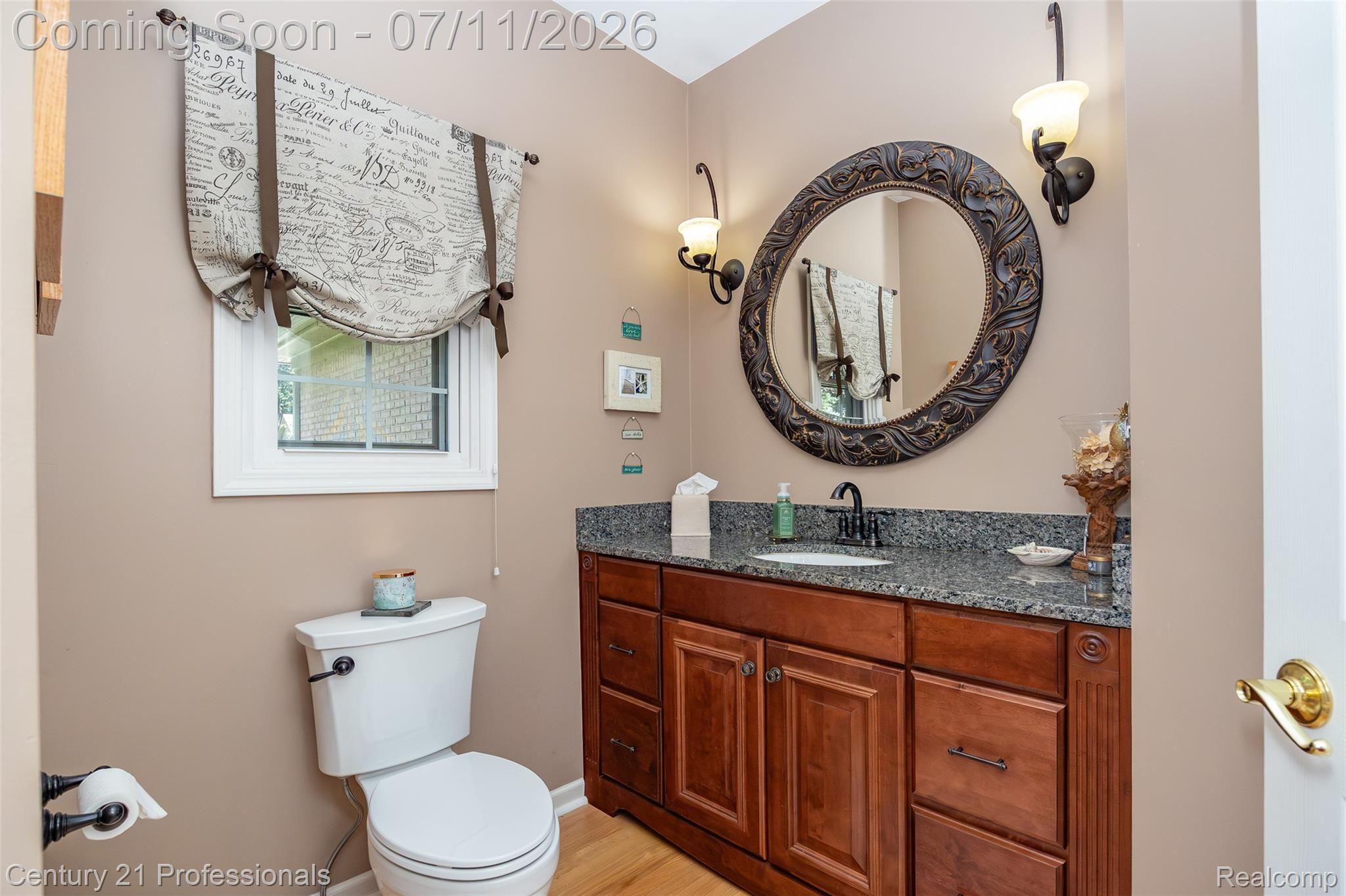 689 Woodfield Way Rochester, MI 48307 - Photo 21 of 61 Bathroom featuring a vanity with a dark granite countertop, an undermount sink, and a dark wood-finish cabinet with brass hardware