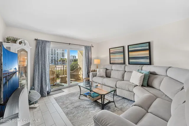 a living room with furniture and a painting on the wall