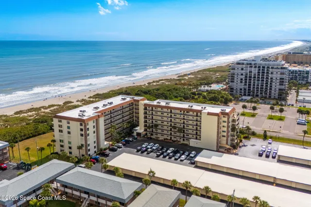 a view of a hallway view with wooden floor and a living room
