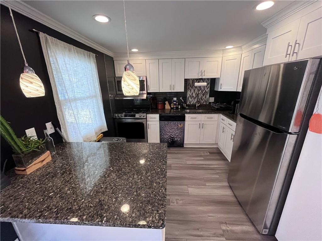 1875 Linton Street Pittsburgh, PA 15219 - Photo 12 of 24 a kitchen with stainless steel appliances granite countertop a refrigerator stove microwave and sink