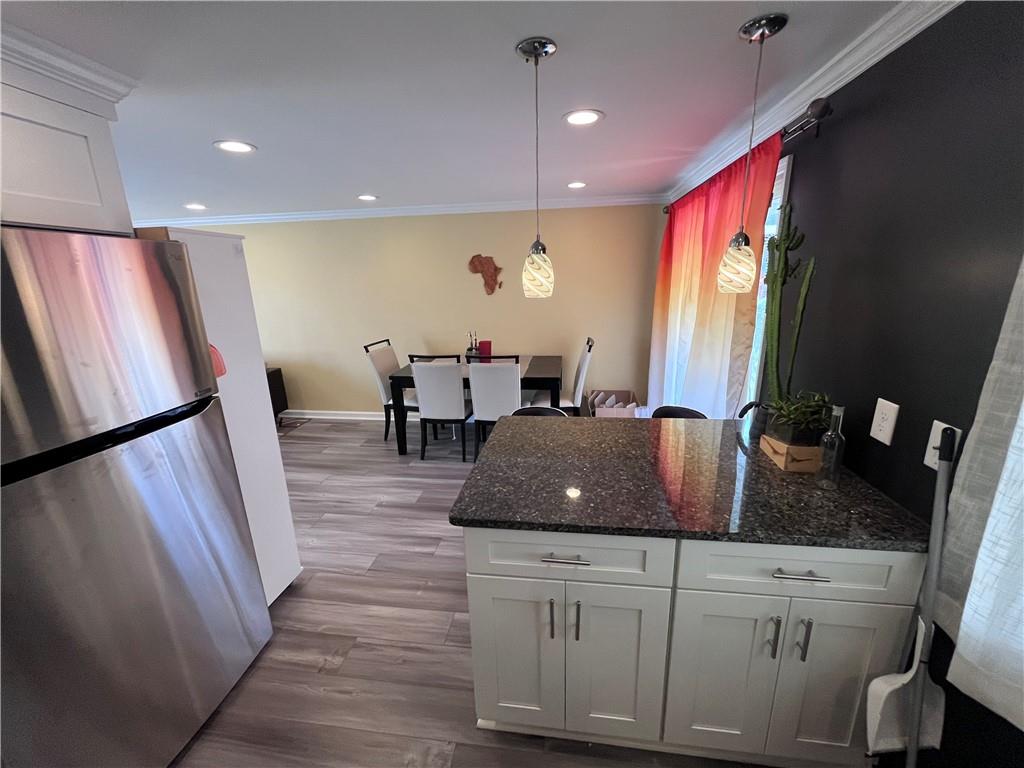 1875 Linton Street Pittsburgh, PA 15219 - Photo 13 of 24 a kitchen with stainless steel appliances granite countertop a refrigerator sink and wooden floor