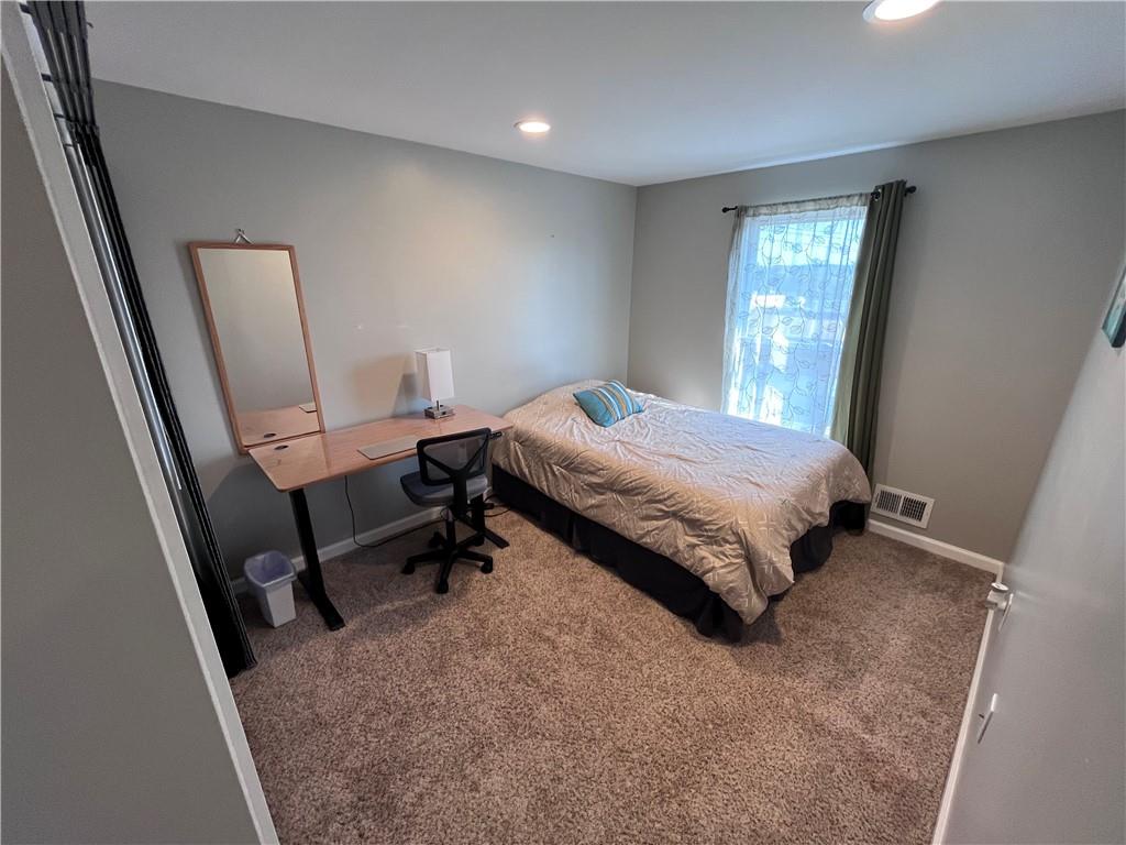 1875 Linton Street Pittsburgh, PA 15219 - Photo 19 of 24 a bed sitting in a bedroom next to a window