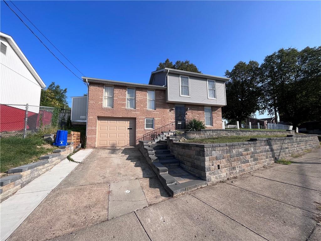 1875 Linton Street Pittsburgh, PA 15219 - Photo 2 of 24 a front view of a house with a yard and tree s