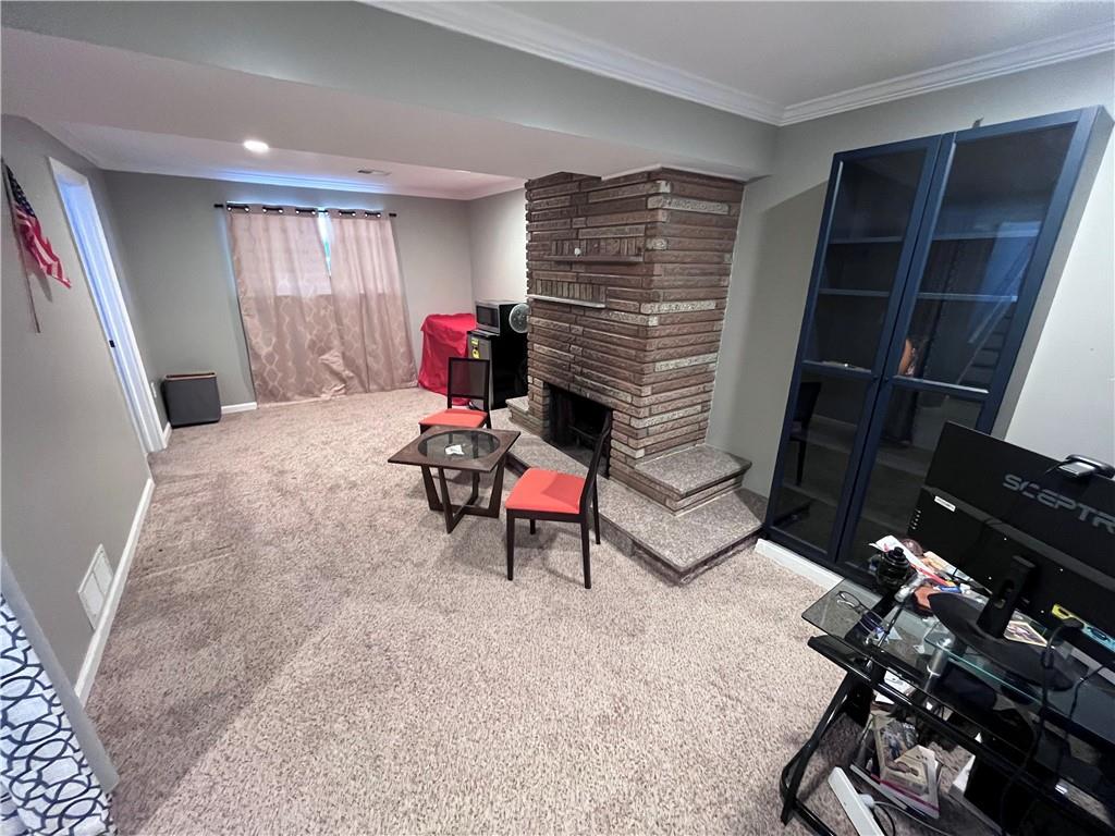 1875 Linton Street Pittsburgh, PA 15219 - Photo 5 of 24 a living room with furniture a rug and white walls