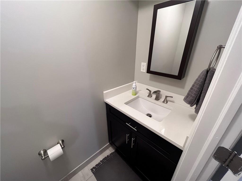 1875 Linton Street Pittsburgh, PA 15219 - Photo 8 of 24 a bathroom with a sink vanity and a mirror