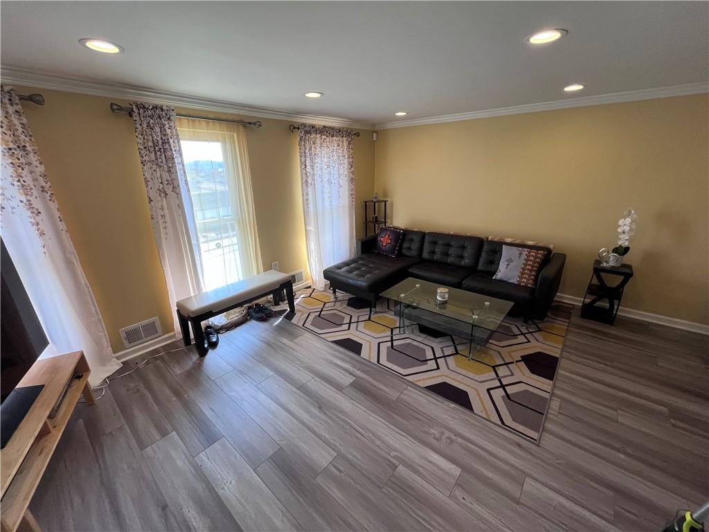 1875 Linton Street Pittsburgh, PA 15219 - Photo 10 of 24 a living room with furniture and a wooden floor