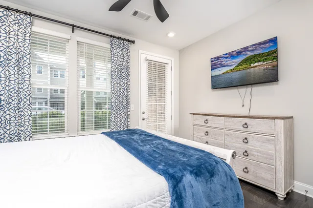 a bedroom with a bed and a flat screen tv