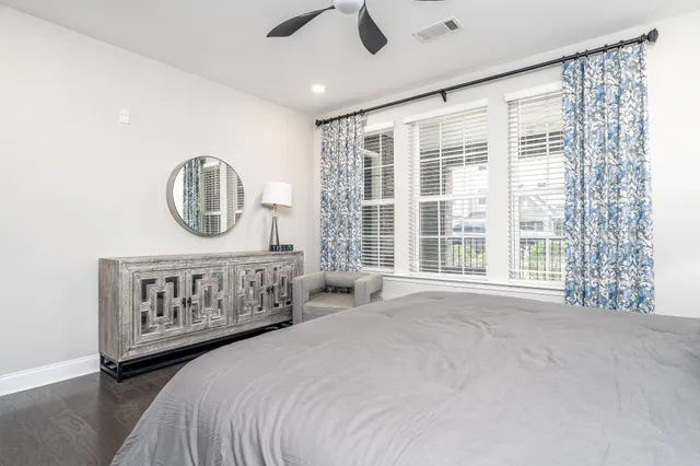 a bedroom with a large bed and a large window