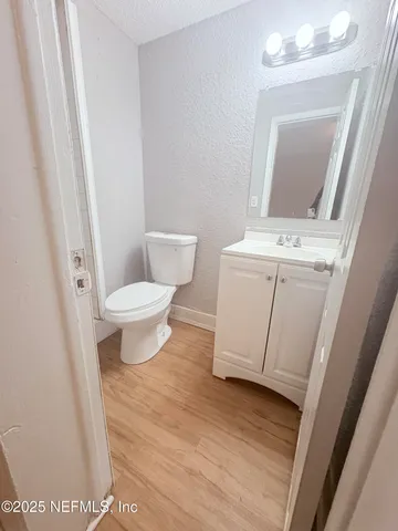 a bathroom with a toilet a sink and a mirror